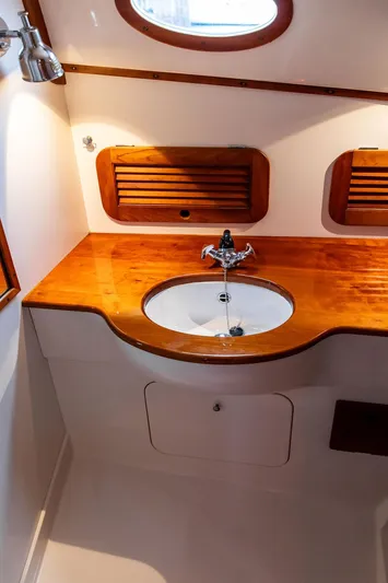 Belle Yacht Photos Pics 1998 Hinckley Picnic Boat bathroom with wooden countertop and sink.