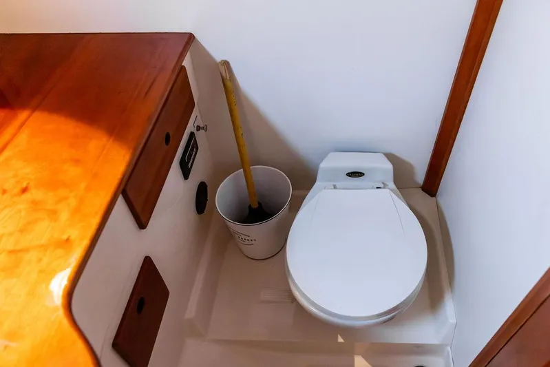 Belle Yacht Photos Pics 1998 Hinckley Picnic Boat interior with toilet and wooden cabinetry.