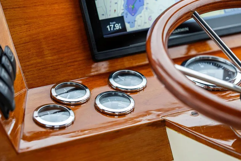 Belle Yacht Photos Pics 1998 Hinckley Picnic Boat dashboard with wooden steering wheel and navigation instruments.
