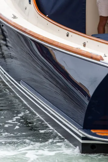 Belle Yacht Photos Pics 1998 Hinckley Picnic Boat with sleek navy hull on water.