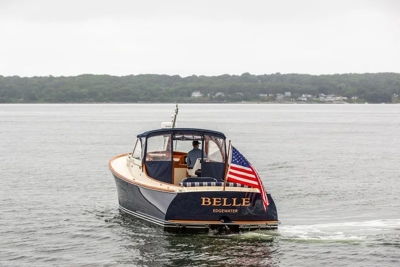 Belle Yacht Photos Pics 1998 Hinckley Picnic Boat "Belle" cruising on calm waters with American flag.
