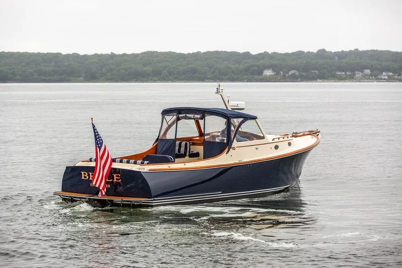 Belle Yacht Photos Pics 1998 Hinckley Picnic Boat cruising on calm waters with American flag.