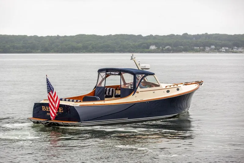 Belle Yacht Photos Pics 1998 Hinckley Picnic Boat cruising on calm waters with American flag.