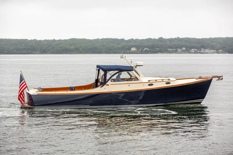 Belle Yacht Photos Pics 1998 Hinckley Picnic Boat cruising on calm waters with American flag.