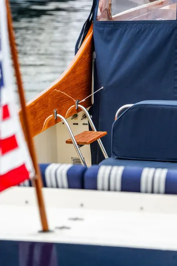 Belle Yacht Photos Pics 1998 Hinckley Picnic Boat with blue upholstery and American flag detail.