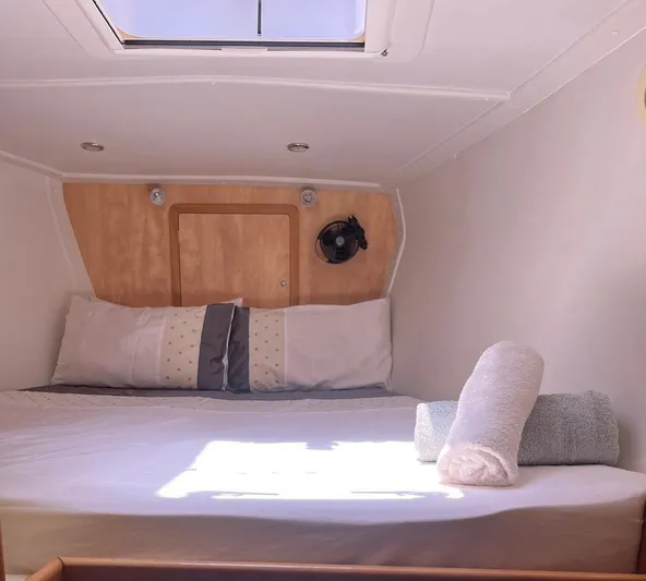  Yacht Photos Pics Cozy cabin interior of 2012 Royal Cape Catamarans Majestic 53 with skylight and bedding.