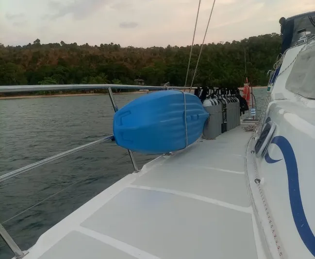  Yacht Photos Pics Deck view of 2012 Royal Cape Catamarans Majestic 53 with blue fender and scenic backdrop.