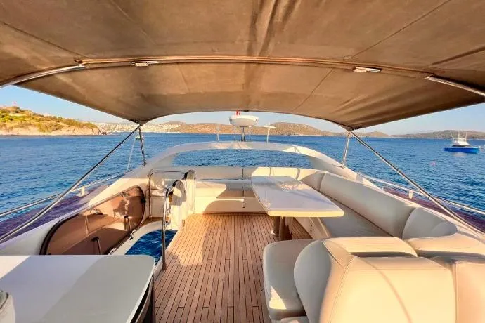  Yacht Photos Pics 2015 Princess Flybridge 52 Motor Yacht with spacious deck and seating, cruising on serene waters.