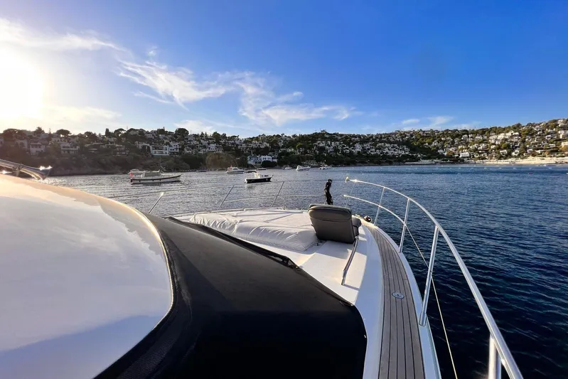  Yacht Photos Pics 2015 Princess Flybridge 52 Motor Yacht cruising near scenic coastal town.