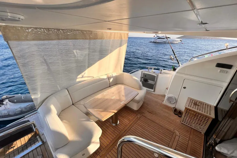  Yacht Photos Pics Luxurious 2015 Princess Flybridge 52 Motor Yacht with elegant deck seating and ocean view.