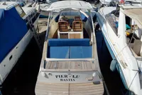 2010 Rhea 35 Open boat docked, featuring blue seating and wooden deck.