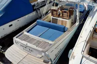 2010 Rhea 35 Open boat with blue seating, docked among other vessels.