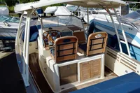2010 Rhea 35 Open boat interior with wooden dashboard and seating.