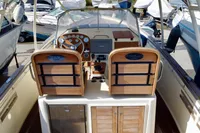 2010 Rhea 35 Open boat cockpit with wooden helm and modern controls.