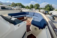 2010 Rhea 35 Open boat with blue seating, docked in a marina under a clear sky.