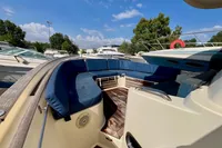 2010 Rhea 35 Open boat with blue seating, docked under a clear sky.