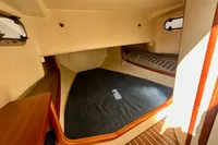 Interior cabin of 2010 Rhea 35 Open boat with wooden accents and carpeted floor.