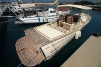 2010 Rhea 35 Open boat docked at marina, featuring spacious deck and seating.