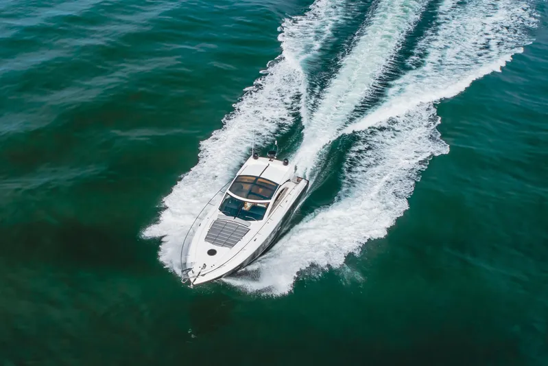 Tranquility Yacht Photos Pics 2012 Sunseeker Portofino 48 yacht cruising on open water, aerial view.