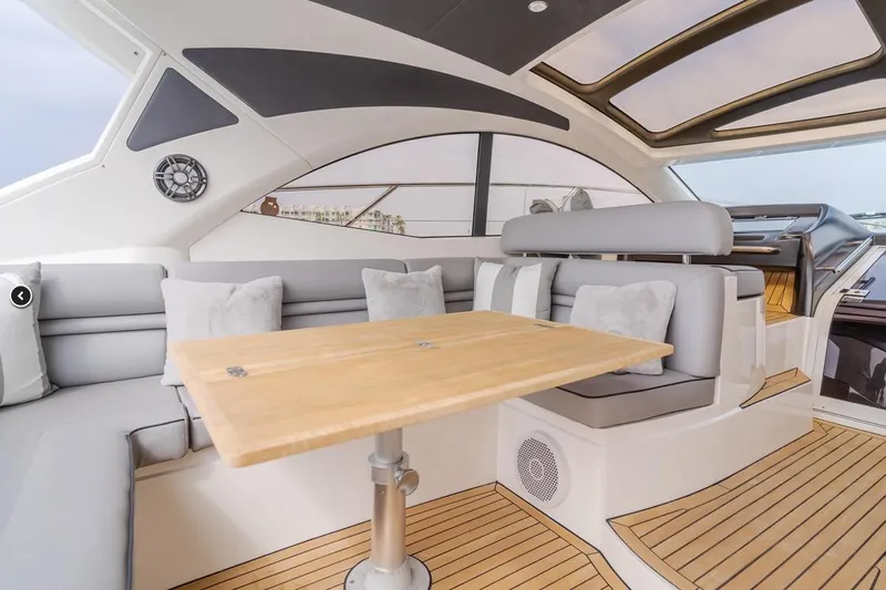 Tranquility Yacht Photos Pics Luxurious interior of 2012 Sunseeker Portofino 48 yacht with elegant seating and wooden table.
