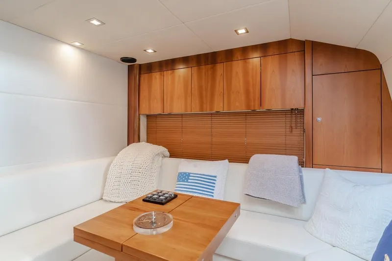 Tranquility Yacht Photos Pics Luxurious interior of 2012 Sunseeker Portofino 48 yacht with cozy seating and wooden accents.
