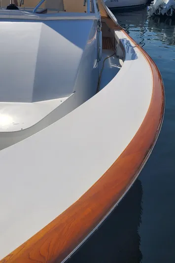 Charmer Yacht Photos Pics 1985 Rybovich 32 Express Walkaround Sportfish boat with sleek wooden trim detail.