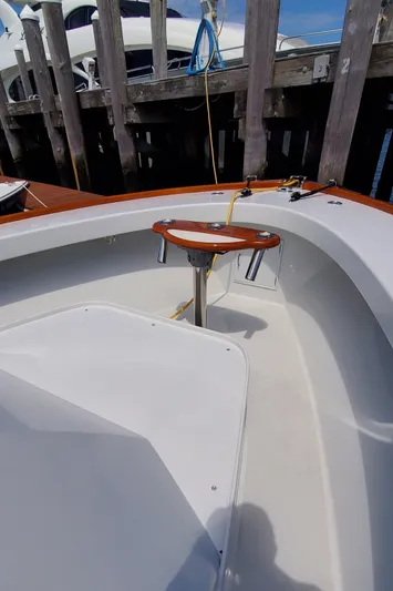 Charmer Yacht Photos Pics 1985 Rybovich 32 Express Walkaround Sportfish boat interior with wooden accents and dock view.