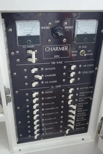 Charmer Yacht Photos Pics Electrical panel of a 1985 Rybovich 32 Express Walkaround Sportfish boat, featuring various switches and meters.