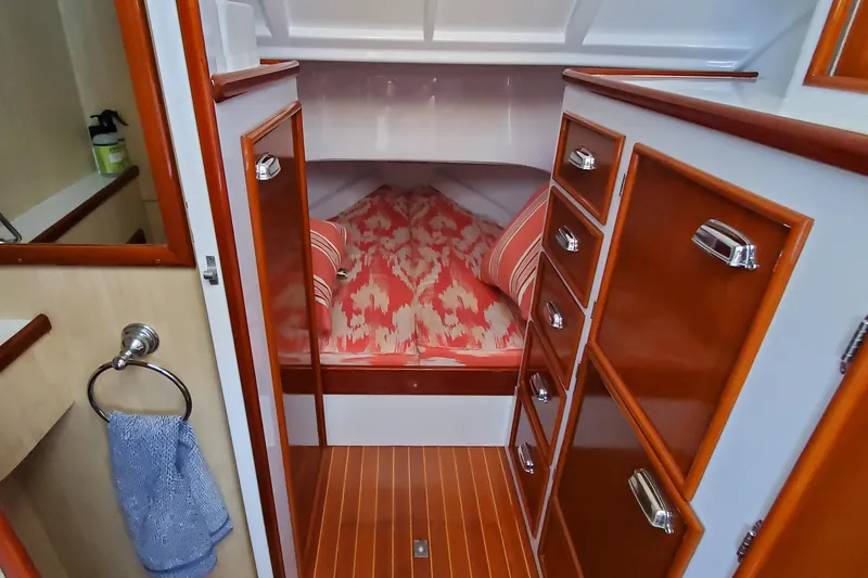 Charmer Yacht Photos Pics 1985 Rybovich 32 Express Walkaround Sportfish cabin with wood cabinetry and cozy bed.