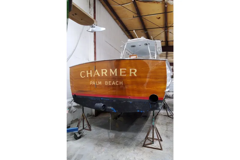 Charmer Yacht Photos Pics 1985 Rybovich 32 Express Walkaround Sportfish boat in a warehouse, named "Charmer."