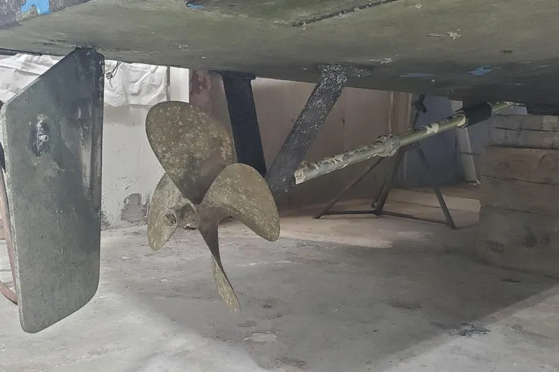 Charmer Yacht Photos Pics Propeller and rudder of a 1985 Rybovich 32 Express Walkaround Sportfish boat in dry dock.
