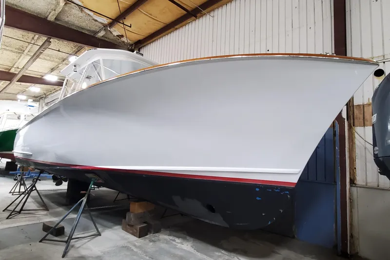 Charmer Yacht Photos Pics 1985 Rybovich 32 Express Walkaround Sportfish in a boatyard, side view.