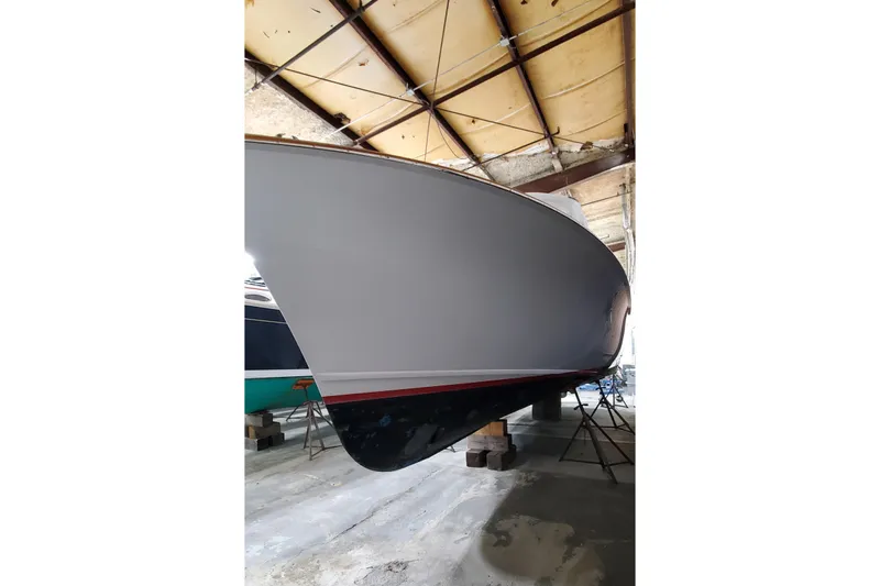 Charmer Yacht Photos Pics 1985 Rybovich 32 Express Walkaround Sportfish in a boatyard, side view.