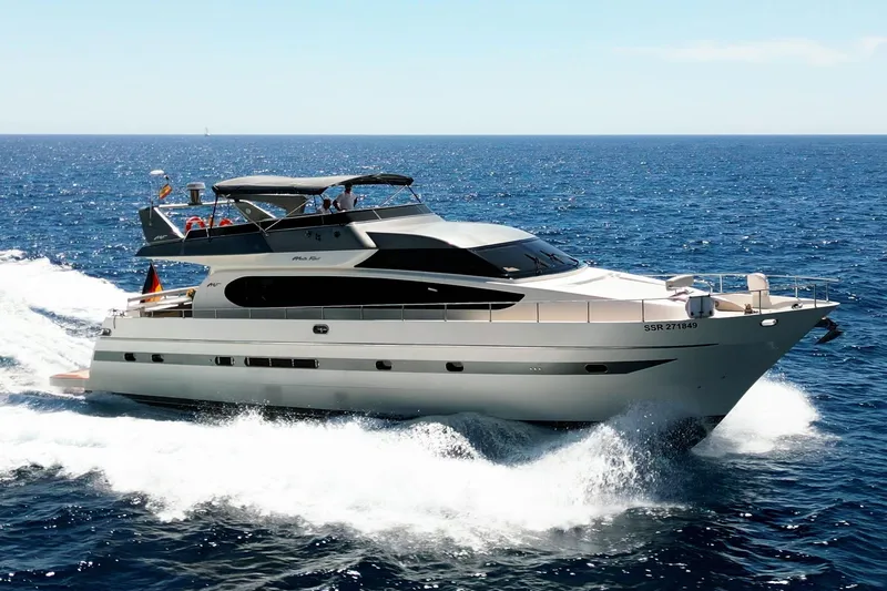 Ma Bella Yacht Photos Pics Luxurious 1999 Monte Fino 72 yacht cruising on open sea under clear skies.
