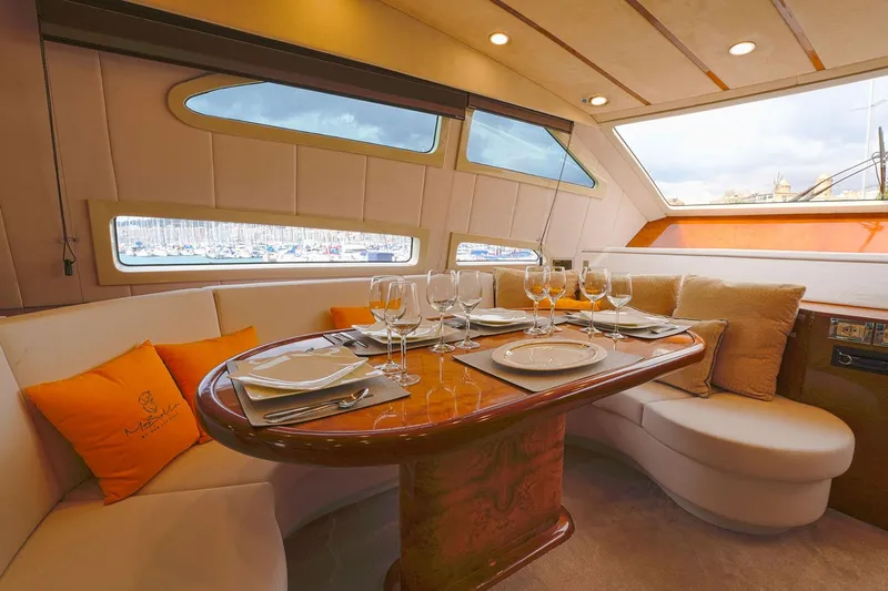 Ma Bella Yacht Photos Pics Luxurious dining area inside 1999 Monte Fino 72 yacht, featuring elegant table settings.