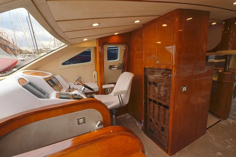 Ma Bella Yacht Photos Pics Luxurious interior of 1999 Monte Fino 72 yacht with polished wood and modern controls.
