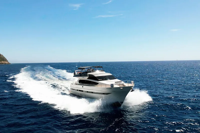 Ma Bella Yacht Photos Pics Luxurious 1999 Monte Fino 72 yacht cruising on open blue sea under clear sky.