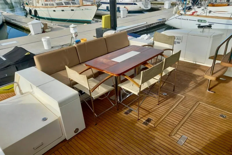 Zero One Yacht Photos Pics Luxury yacht deck with dining area on 2012 Fairline Squadron 65, featuring wooden flooring.