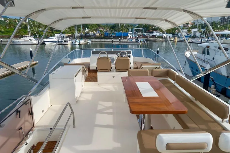 Zero One Yacht Photos Pics Luxurious 2012 Fairline Squadron 65 yacht interior with seating and dining area in marina.