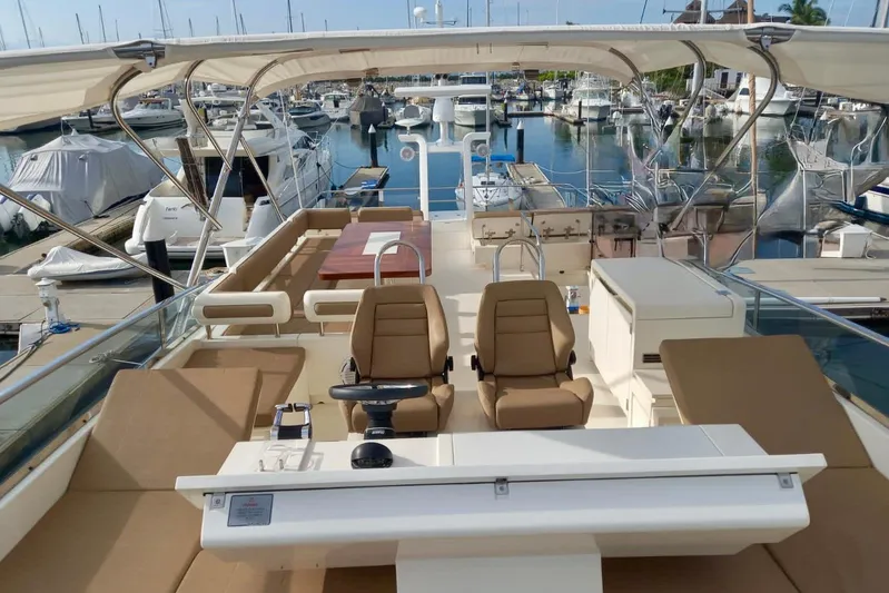 Zero One Yacht Photos Pics Flybridge of 2012 Fairline Squadron 65 yacht in marina, featuring luxurious seating and helm.