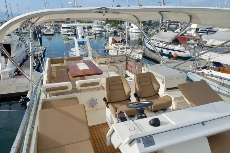 Zero One Yacht Photos Pics Luxurious 2012 Fairline Squadron 65 yacht interior at marina, featuring elegant seating and helm.