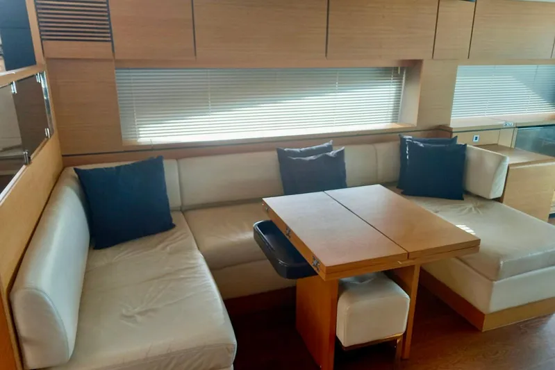 Zero One Yacht Photos Pics Luxurious interior of 2012 Fairline Squadron 65 yacht with elegant seating and wooden table.