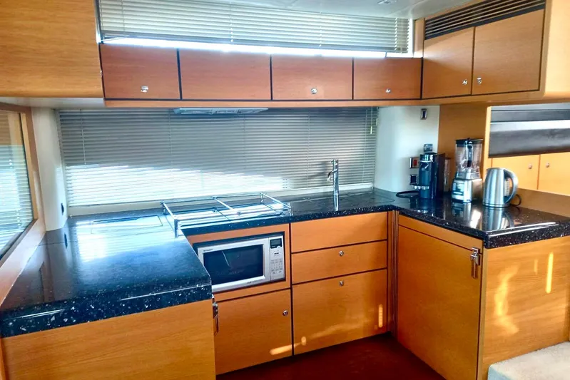 Zero One Yacht Photos Pics Modern kitchen interior on 2012 Fairline Squadron 65 yacht with wooden cabinets and appliances.