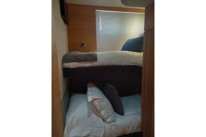 Zero One Yacht Photos Pics Bunk beds in 2012 Fairline Squadron 65 yacht cabin with wooden paneling and blinds.