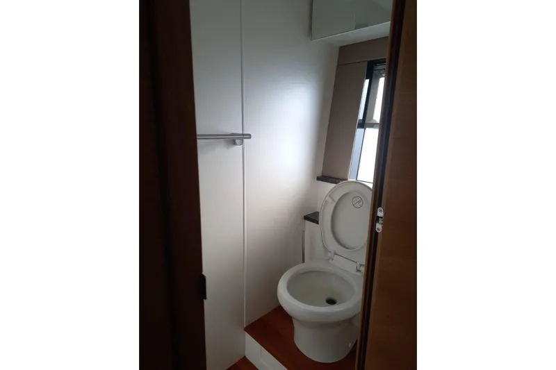 Zero One Yacht Photos Pics Bathroom interior of 2012 Fairline Squadron 65 yacht, featuring a toilet and window.