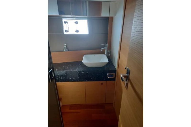 Zero One Yacht Photos Pics Modern bathroom interior on 2012 Fairline Squadron 65 yacht, featuring sleek sink and wooden cabinetry.