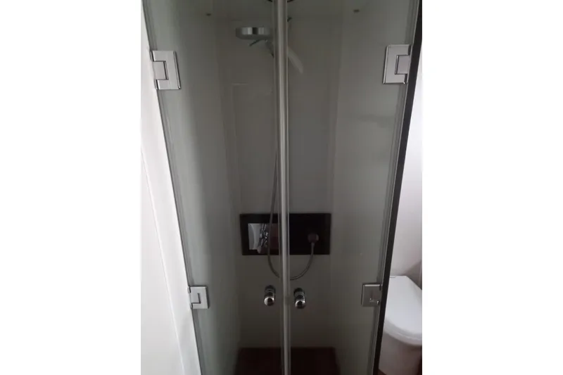 Zero One Yacht Photos Pics Shower area in 2012 Fairline Squadron 65 yacht, featuring glass doors and modern fixtures.