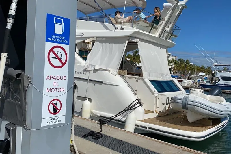 Zero One Yacht Photos Pics 2012 Fairline Squadron 65 yacht docked at marina with safety signs visible.