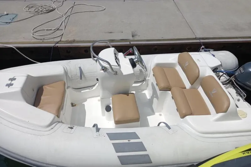 Zero One Yacht Photos Pics Small inflatable boat with tan seats docked, associated with 2012 Fairline Squadron 65.