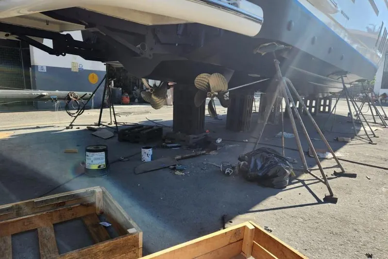 Zero One Yacht Photos Pics 2012 Fairline Squadron 65 yacht under maintenance, showing propellers and support stands.